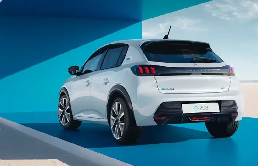 2023 Peugeot e-208, white, CGI background, rear three-quarters